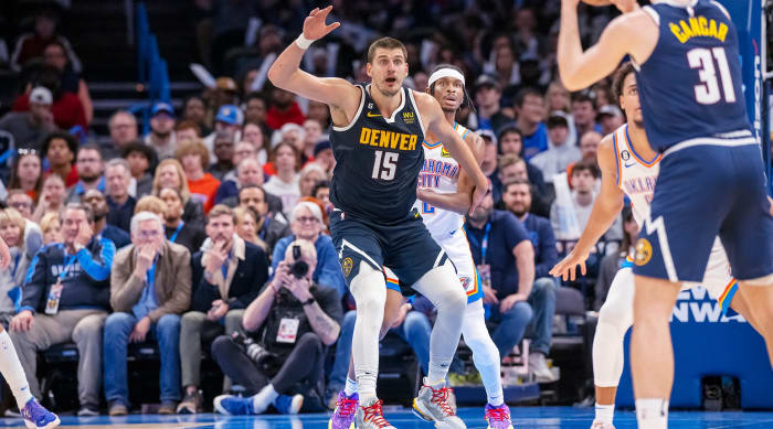 Denver Nuggets center Nikola Jokić jostles for position in the post against Oklahoma City Thunder guard Shai Gilgeous-Alexander.